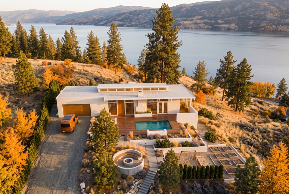 Autumn aerial: pool, fire pit, beds, play yard in one frame.